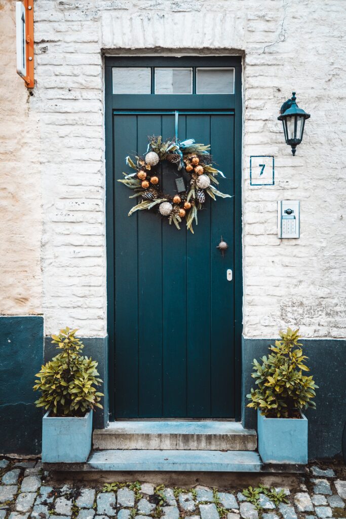 a picture with wreaths on the entrance door